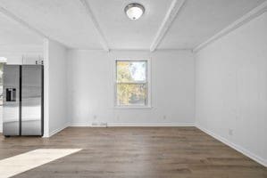 spare room with wood-type flooring