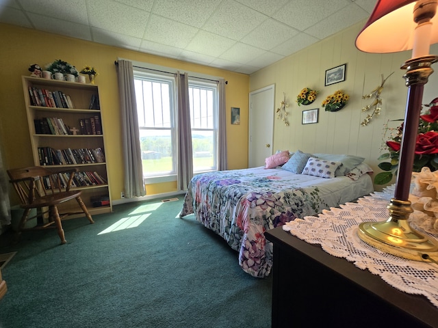 carpeted bedroom with a paneled ceiling