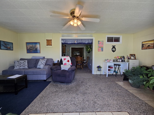 living room with ceiling fan and carpet