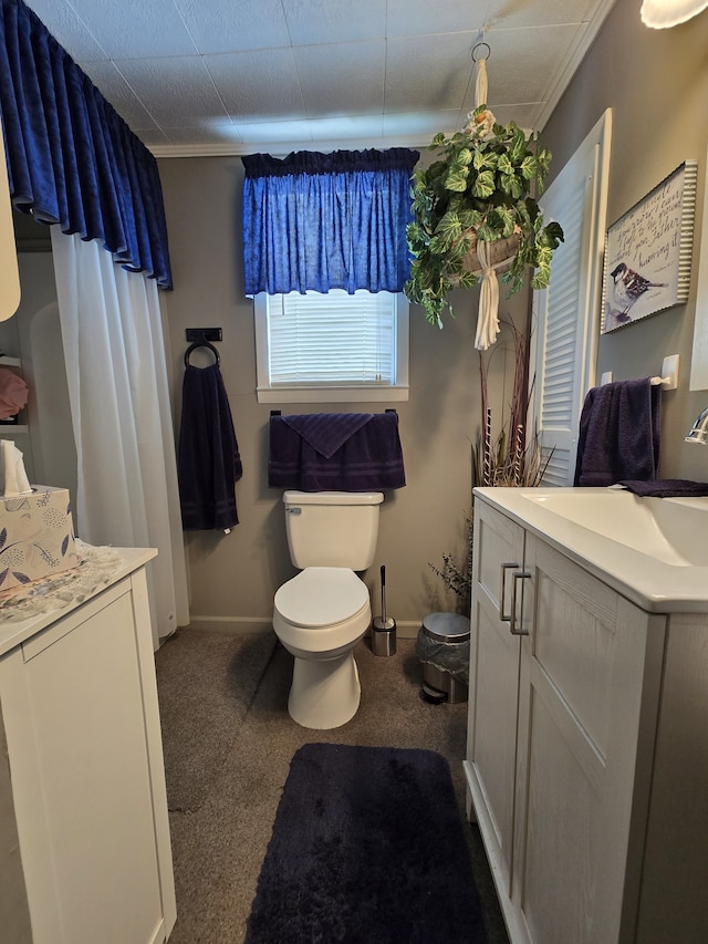 bathroom featuring vanity, crown molding, and toilet