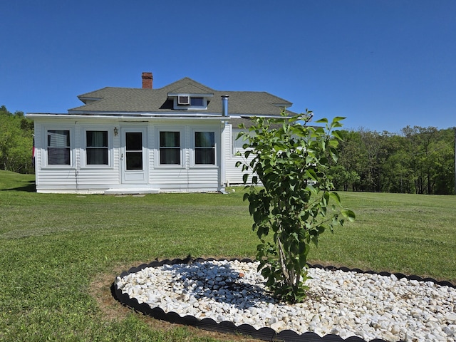 back of property with a yard