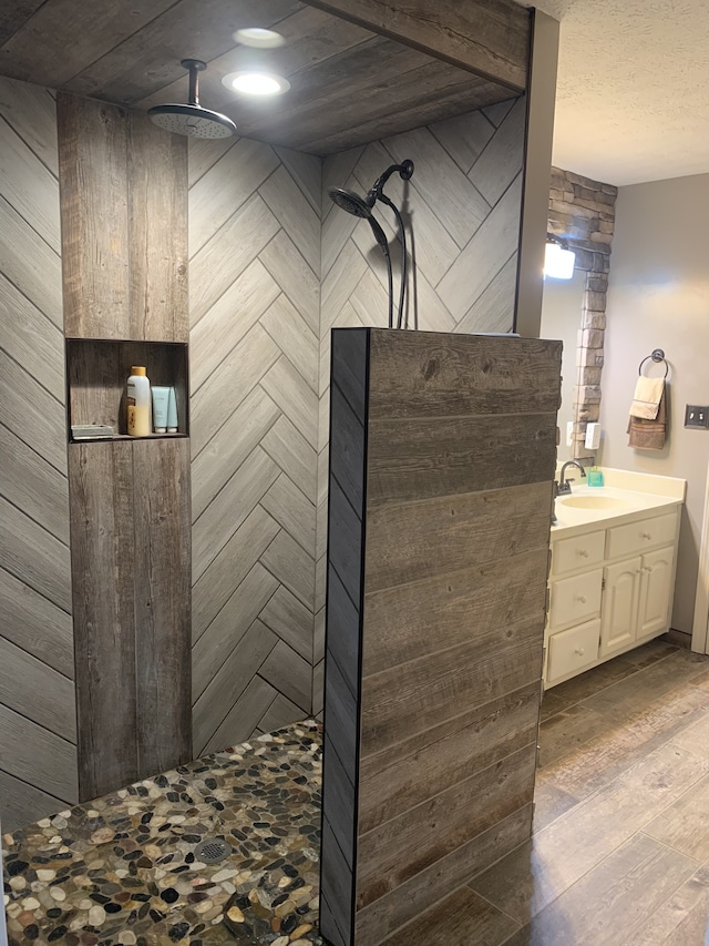 bathroom featuring vanity, hardwood / wood-style flooring, and a shower