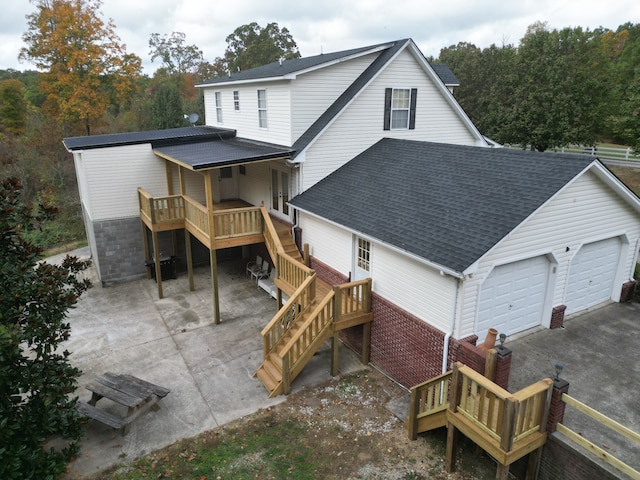 rear view of property featuring a garage