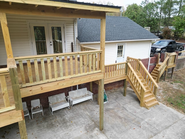 deck with french doors and a patio