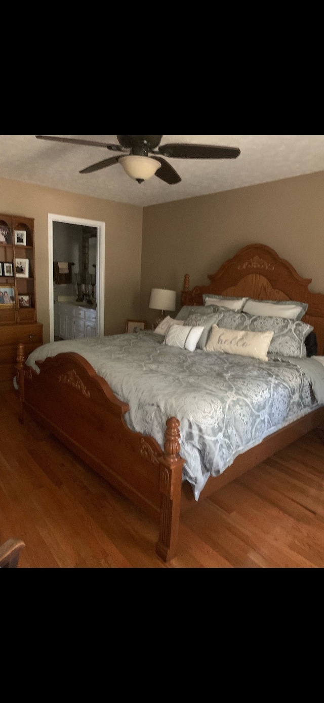 bedroom with ceiling fan and wood-type flooring