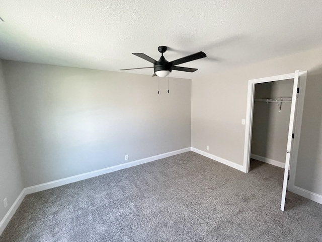 unfurnished bedroom featuring a closet, ceiling fan, carpet flooring, and a textured ceiling