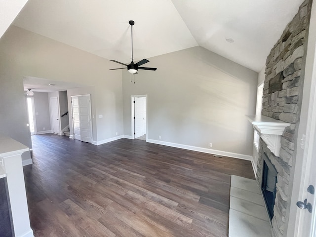 unfurnished living room featuring dark hardwood / wood-style flooring, ceiling fan, a fireplace, and vaulted ceiling