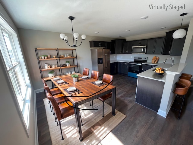 dining area featuring an inviting chandelier and dark hardwood / wood-style floors