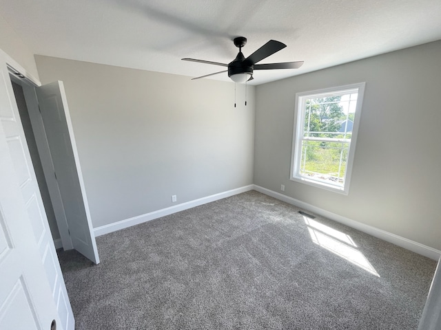 carpeted empty room with ceiling fan