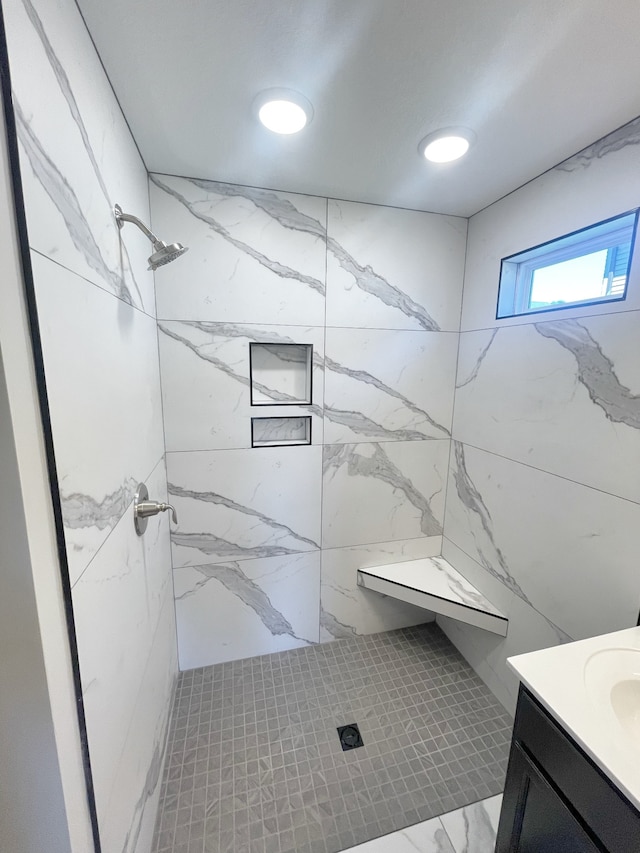 bathroom featuring vanity and tiled shower