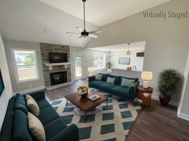 living room featuring light hardwood / wood-style flooring, high vaulted ceiling, a fireplace, and ceiling fan