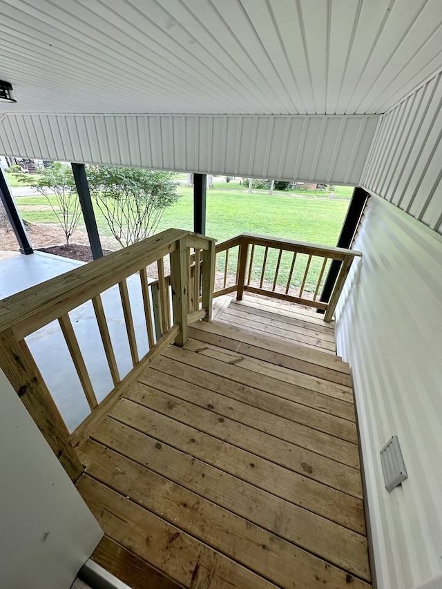 wooden terrace featuring a yard