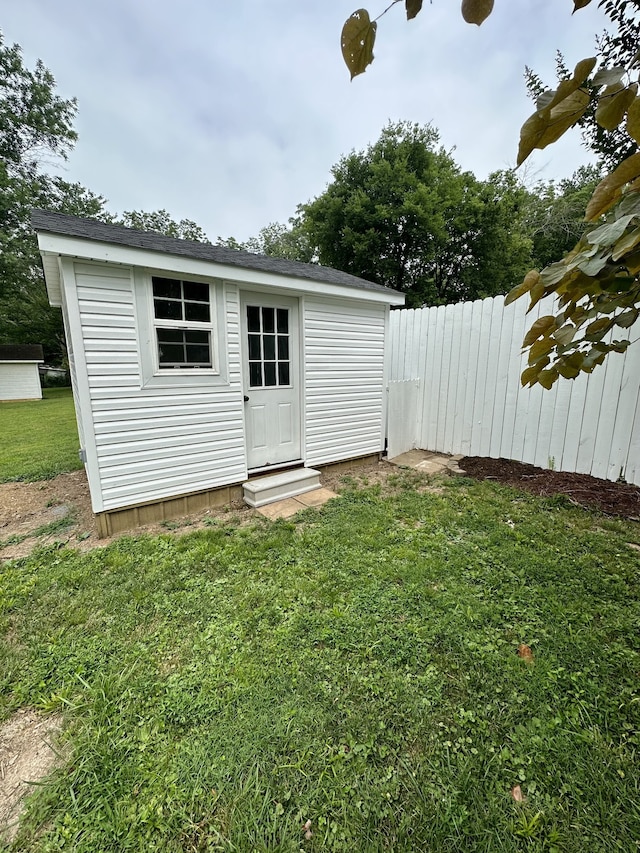 view of outdoor structure featuring a lawn