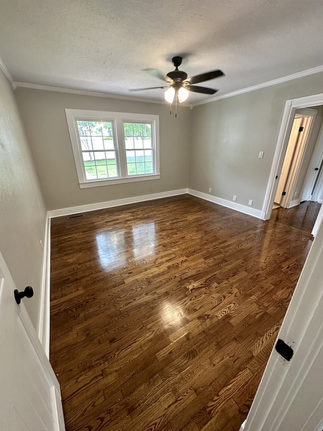 unfurnished room featuring ceiling fan, dark hardwood / wood-style flooring, ornamental molding, and a textured ceiling