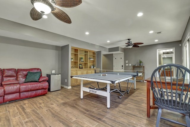 recreation room featuring ceiling fan and hardwood / wood-style floors