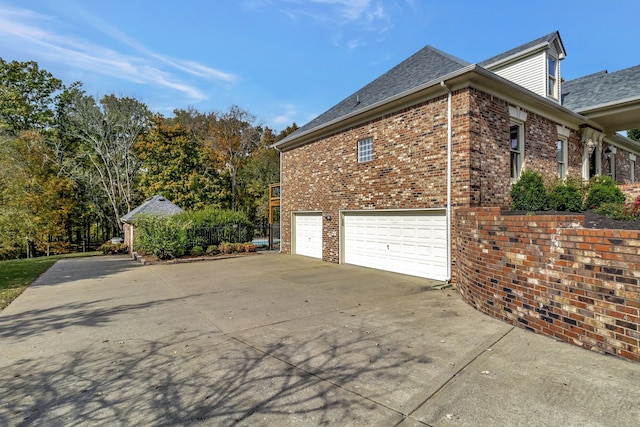 view of side of home featuring a garage