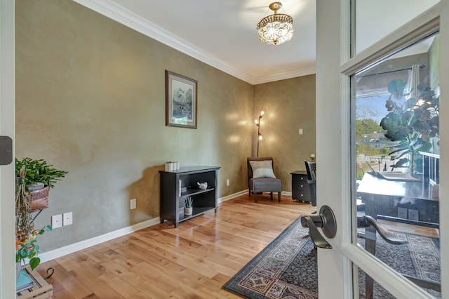 living area featuring ornamental molding and hardwood / wood-style floors