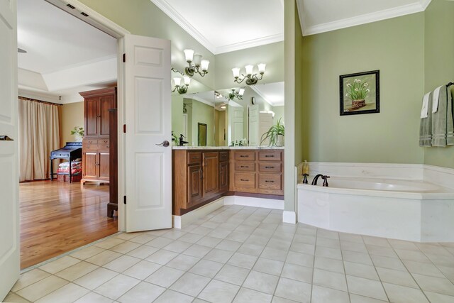 bathroom with a bath, crown molding, wood-type flooring, and vanity