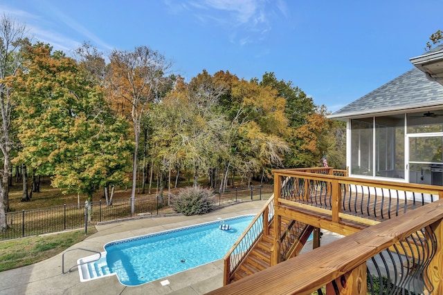 view of swimming pool featuring a patio and a sunroom