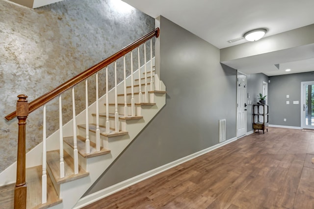 stairway with hardwood / wood-style flooring