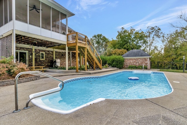 view of swimming pool with a patio and a sunroom