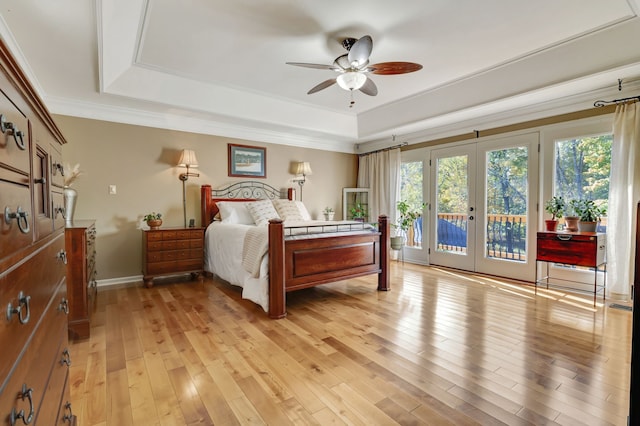 bedroom featuring ceiling fan, access to exterior, light hardwood / wood-style flooring, ornamental molding, and french doors