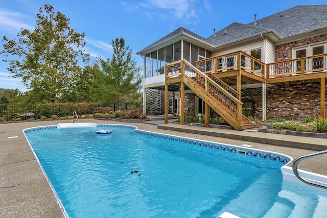 view of swimming pool with a wooden deck