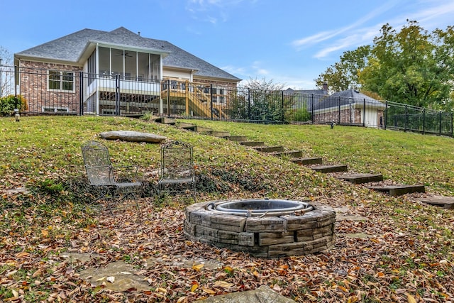 view of yard with a fire pit and a sunroom