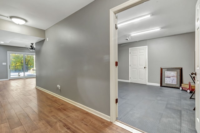 hall with wood-type flooring