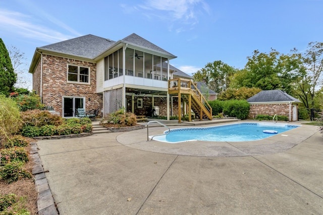 view of swimming pool featuring a patio and a sunroom