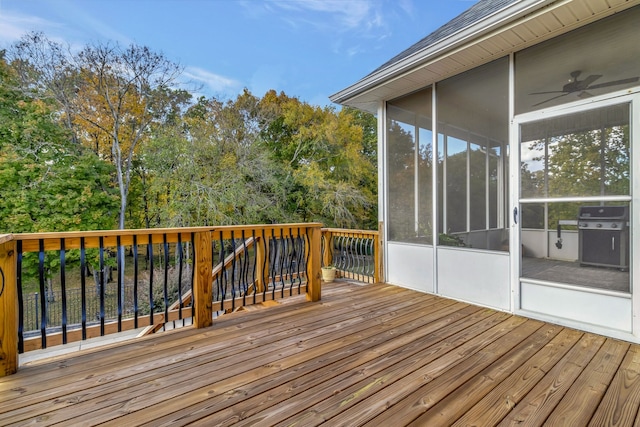 wooden terrace with a grill and a sunroom