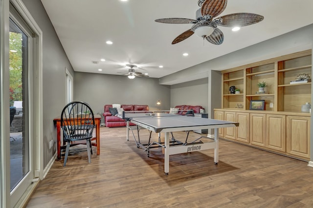 recreation room with hardwood / wood-style floors and ceiling fan