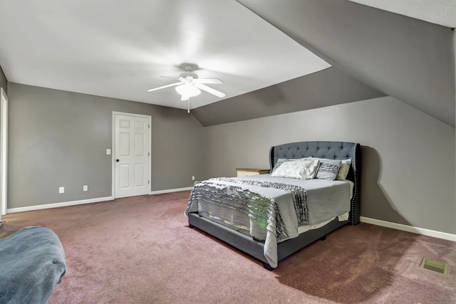 bedroom featuring dark colored carpet, lofted ceiling, and ceiling fan