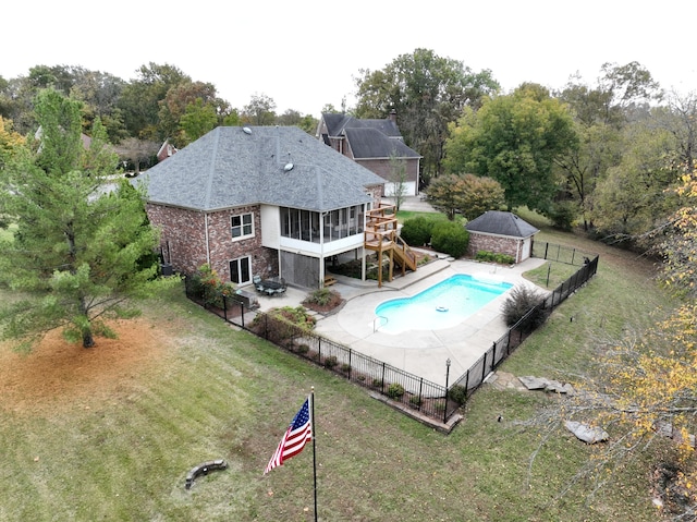 view of pool featuring a patio, a lawn, and a sunroom