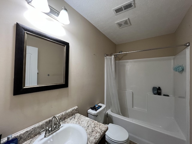 full bathroom featuring a textured ceiling, shower / bathtub combination with curtain, vanity, and toilet