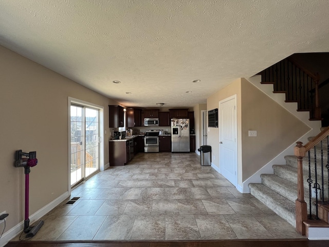 unfurnished living room with a textured ceiling