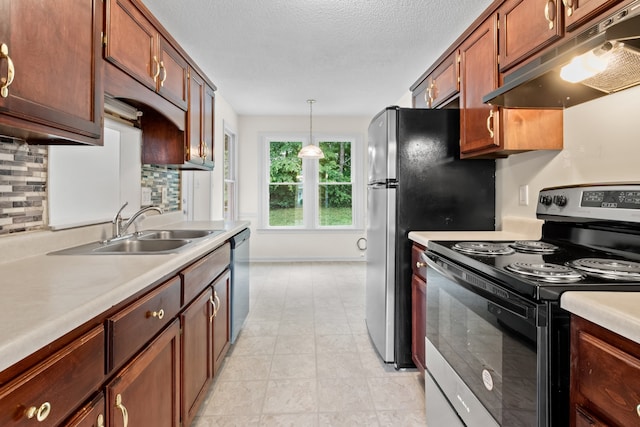 kitchen with hanging light fixtures, backsplash, sink, appliances with stainless steel finishes, and a textured ceiling