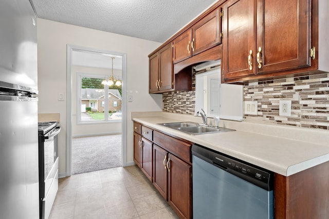 kitchen featuring a textured ceiling, appliances with stainless steel finishes, sink, and tasteful backsplash