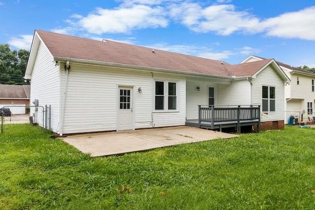 back of house featuring a patio area and a lawn