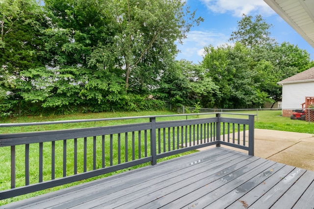 wooden terrace featuring a yard