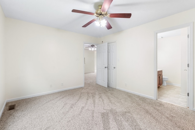 unfurnished bedroom with light carpet, ceiling fan, and ensuite bath