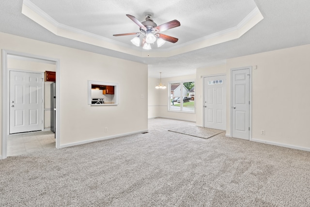 carpeted empty room with crown molding, a textured ceiling, a tray ceiling, and ceiling fan with notable chandelier