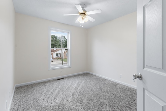 spare room featuring carpet floors and ceiling fan