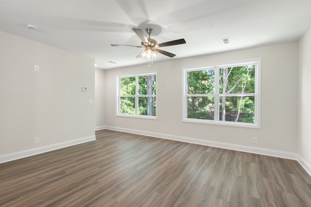 spare room with dark wood-type flooring and ceiling fan