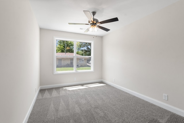 carpeted spare room featuring ceiling fan