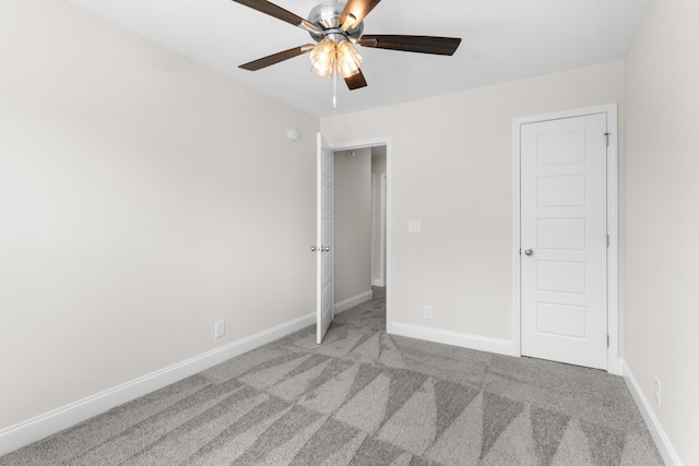 unfurnished bedroom with light colored carpet and ceiling fan