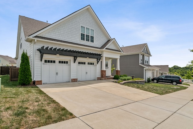 craftsman inspired home featuring a front yard and a garage