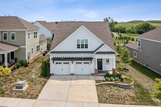 craftsman-style home featuring a front yard and a garage