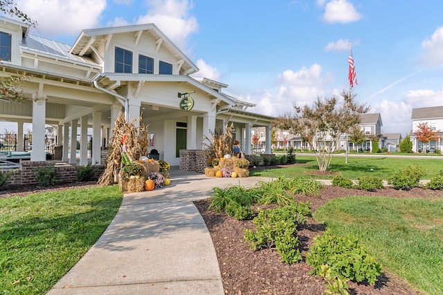 view of front of property with covered porch and a front lawn