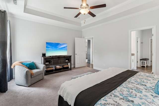 carpeted bedroom with ceiling fan, crown molding, and a raised ceiling